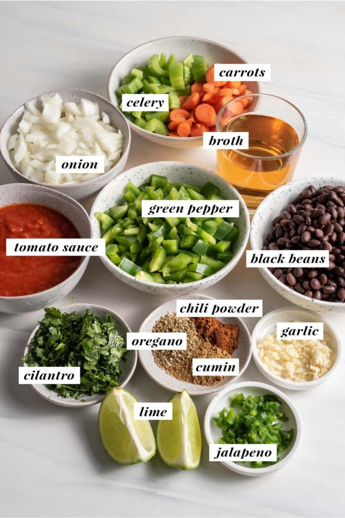 Visual of ingredients needed for making vegan black bean soup, each ingredient labelled with text overlay.