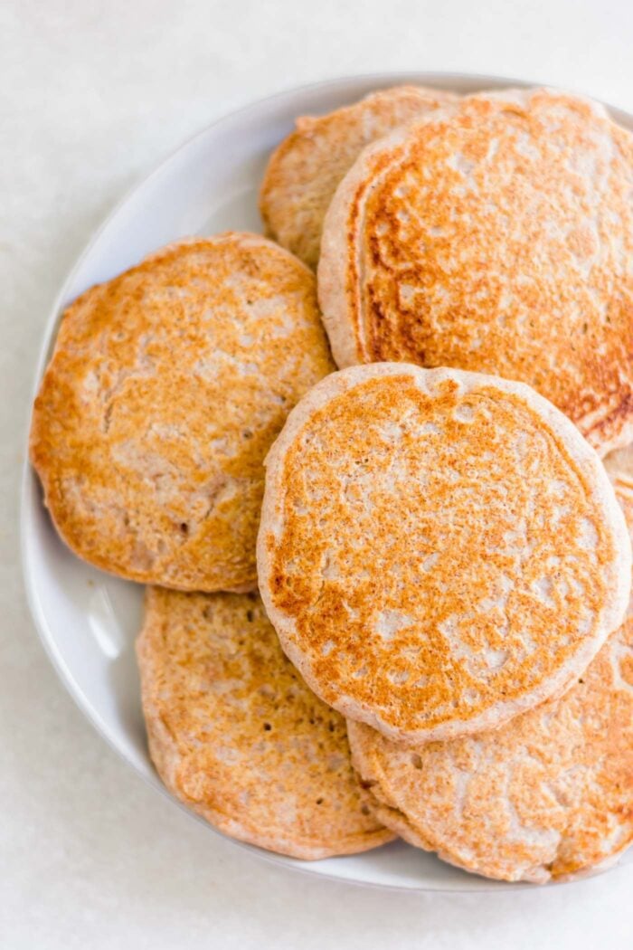 Plate of golden brown, fluffy whole wheat pancakes.