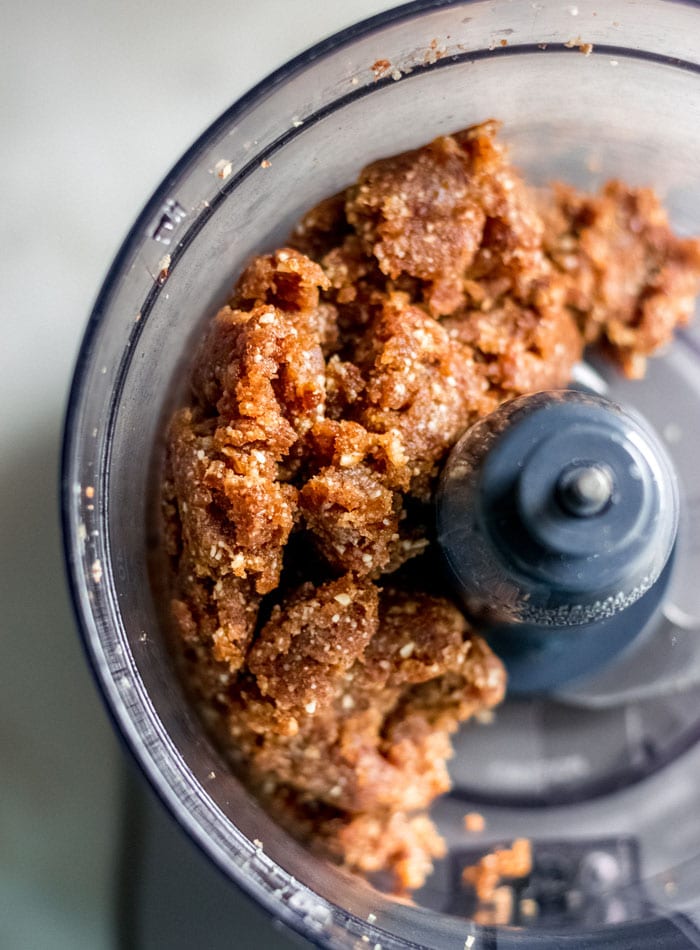 Thick, sticky, date-based dough in a food processor.