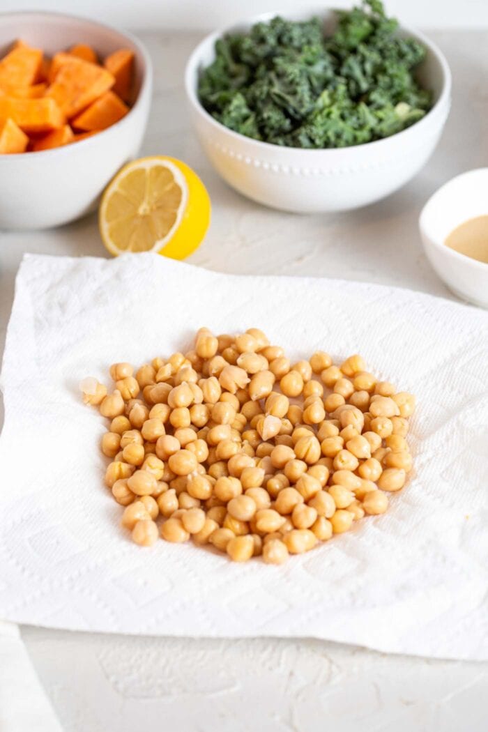 Cooked chickpeas sitting on paper towel.