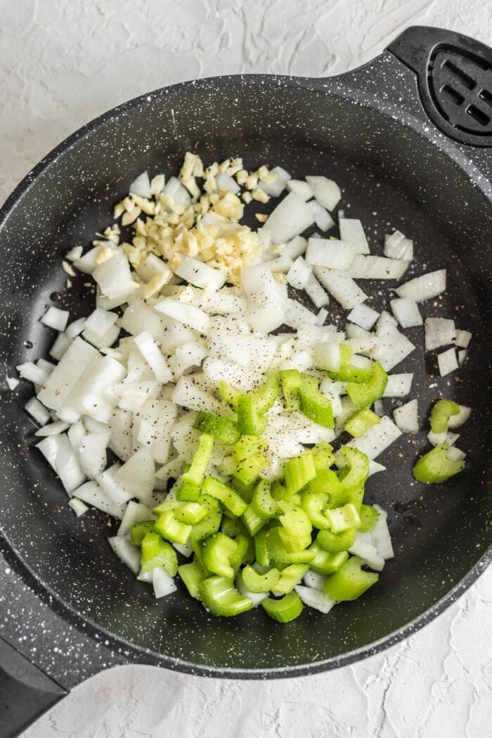 Celery, onion, garlic, salt and pepper in a black skillet.