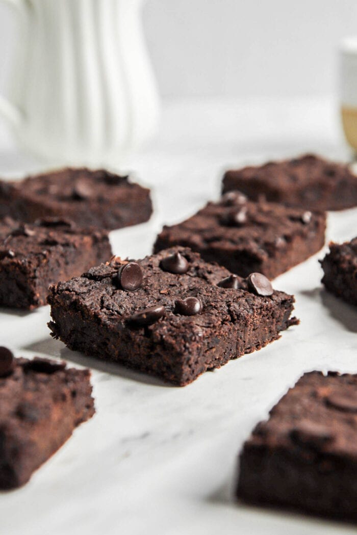 Close up of a black bean chocolate chip brownie on a marble counter top.