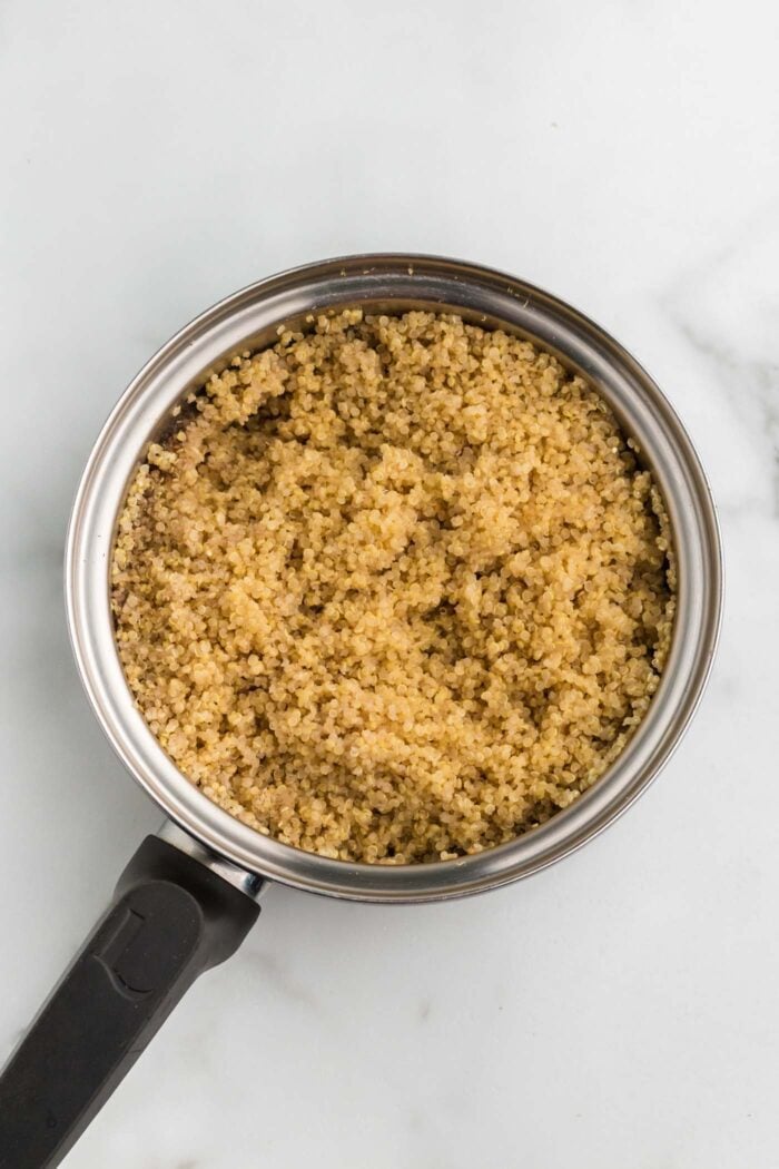 Cooked quinoa in a small pot.