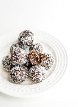 Easy, healthy, no-bake raw vegan hazelnut truffles on a white plate.